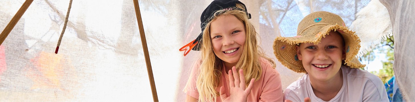Children enjoying building a cubby fort